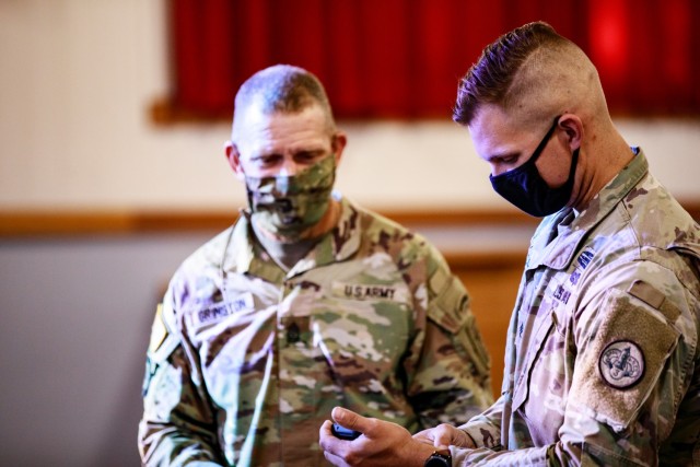 Sgt. Maj. of the Army Michael A. Grinston demos the 'This is My Squad' application with Staff Sgt. Hunter Cozart, cavalry scout, 3d Cavalry Regiment at Fort Hood, Texas, Oct. 27, 2021. Twenty Soldiers from 3d Cavalry Regiment piloted the new app. The goal of the application is to help provide technical tools as another way for Soldiers to build cohesive teams, expand education opportunities, manage time, and to become better leaders. (U.S. Army photo by Staff Sgt. Daniel Herman)