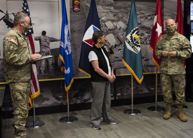 Gen. Ed Daly, commanding general of the U.S. Army Materiel Command, prepares to present a commander’s coin to Cindy Beserra in honor of her 40 years of federal service. Daly made the presentation during an Oct. 27 visit to ASC Headquarters at...