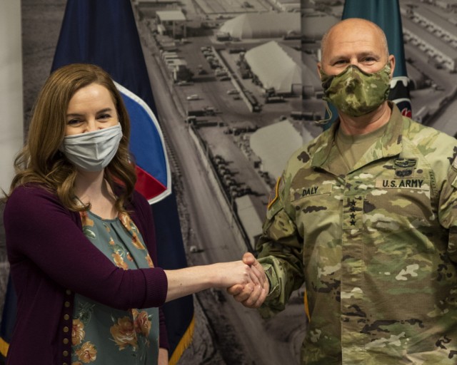 Gen. Ed Daly, commanding general of the U.S. Army Materiel Command, congratulates Ashely Essex after presenting her with a commander’s coin for her work on funding actions related to Operation Allies Welcome. Daly made the presentation during an...
