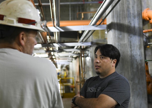 Thomas Yan, Antioch Middle School science teacher, actively listens to Senior Mechanic Greg Forte explain how often staff must regulate equipment to ensure the hydropower plant runs smoothly at the Old Hickory Hydropower Plant in Hendersonville, Tennessee, Oct. 26, 2021. (USACE Photo by Misty Cunningham)