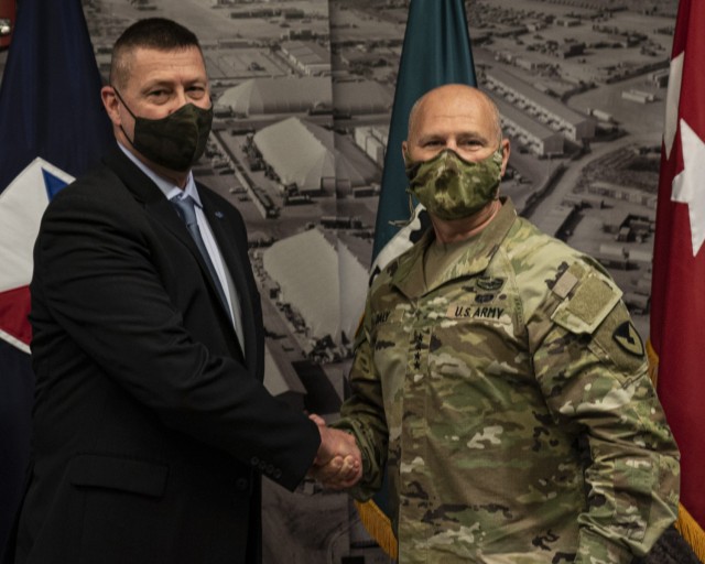 Gen. Ed Daly, commanding general of the U.S. Army Materiel Command, congratulates Steven Wall after presenting him with a commander’s coin for his work on contracting actions during Operation Allies Welcome. Daly made the presentation during an...