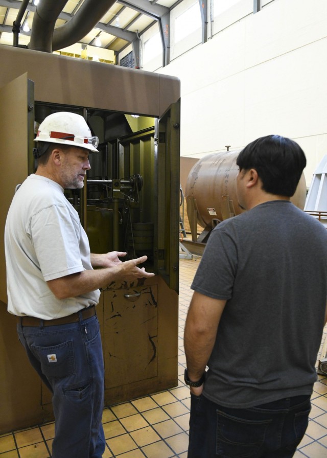 Senior Mechanic Greg Forte explains to science middle school teacher Thomas Yan the complexity involved in the maintenance of hydropower motors during a visit to the dam in Hendersonville, Tennessee, Oct. 26, 2021. (USACE Photo by Misty Cunningham)