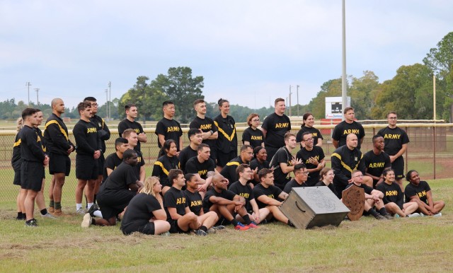 The collected teams that participated in the 1st Cyber Battalion's "mungadai" 24-hour challenge pose for a photo with the battalion time capsule, at Fort Gordon, Ga.,, Oct. 22, 2021. Each team placed an item in the capsule, which will be opened at...