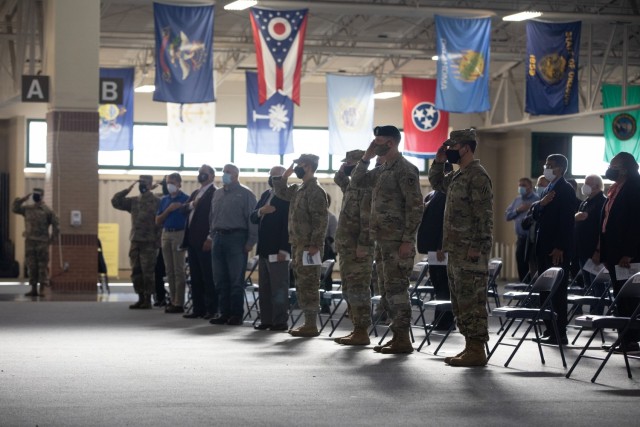 Soldiers and civilians stand and render honors to the flag during the national anthem at Hunter Army Airfield, Georgia, as part of a groundbreaking ceremony, Oct. 29. The ceremony marked the building of a new hangar for the 3rd Combat Aviation Brigade. (U.S. Army photo by Sgt. Andrew McNeil / 3rd Combat Aviation Brigade, 3rd Infantry Division)