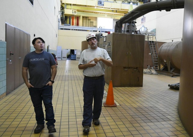 Senior Mechanic Greg Forte walks Thomas Yan, Antioch Middle School science teacher, through the Old Hickory Hydropower Plant Oct. 26, 2021 while he explains just what it takes for an average day’s routine. The dam is located on the Cumberland River in Hendersonville, Tennessee. (USACE Photo by Misty Cunningham)