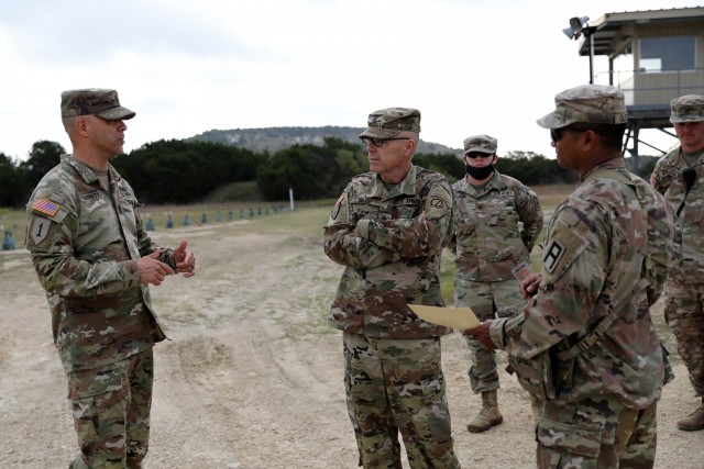 Command Sgt. Maj. Gilbert Garrett, left, command sergeant major for the 2nd Battalion, 337 Regiment, based out of Waterford, Michigan, briefs Command Sgt. Maj. Steven Slee, center, command sergeant major for the 85th U.S. Army Reserve Support Command, on his battalion’s mission during their mobilization at Fort Hood, Texas, October 20, 2021. The 2-337 is one of three battalions currently mobilized to Fort Hood in support of First Army’s 120th Infantry Brigade mission to train, coach and ready Army units ahead of overseas deployments.
(U.S. Army Reserve photo by Anthony L. Taylor)