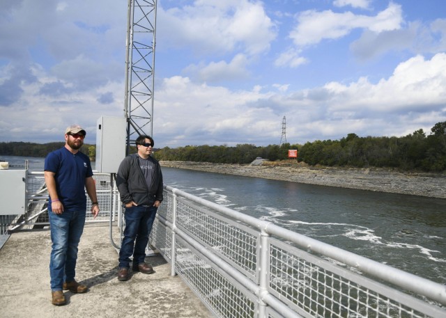 Antioch Middle School science teacher Thomas Yan and Old Hickory Lock and Dam Equipment Mechanic Supervisor Justin Gray watch Oct. 26, 2021 as a fishing boat makes its way through the Old Hickory Lock on the Cumberland River in Old Hickory, Tennessee. (USACE Photo by Misty Cunningham)