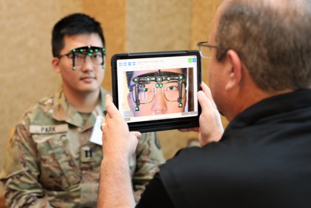 An Army dentist is measured for a pair of optical loupes. Dental loupes are magnifying glasses that dentists wear to assist them in performing intricate dental procedures inside the mouth.