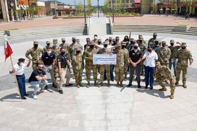 Better Opportunities for Single Soldiers representatives assigned to units across Camp Humphreys, Republic of Korea show their team spirit during a group photo in the center of Downtown Humphreys Aug. 6, 2021. (U.S. Army photo courtesy of U.S. Army Garrison Humphreys BOSS program)