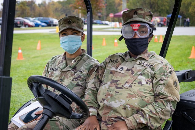 Staff Sgt. Janel Valdez (left,) materiel manager, 1st Theater Sustainment Command, and Staff Sgt. Kierra Magee, materiel manager, 1st TSC, prepare to participate in an obstacle course wearing Fatal Vision Impairment Goggles during the 1st TSC...