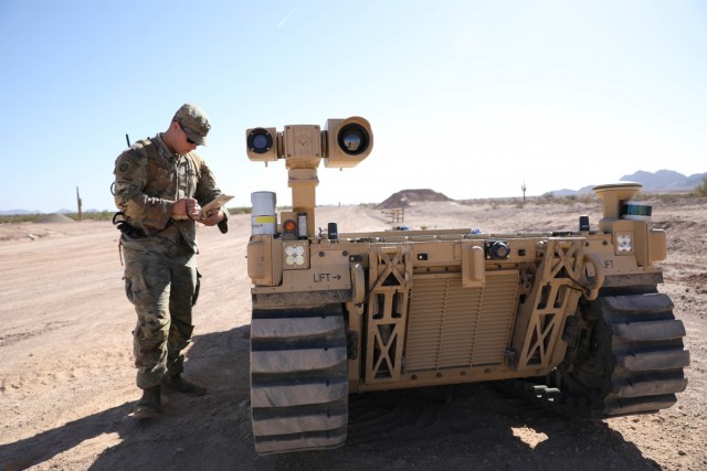 U.S. Army Pfc. Daniel Candales, assigned to the 82nd Airborne Division, uses the tactical robotic controller to control the expeditionary modular autonomous vehicle as a practice exercise in preparation for Project Convergence at Yuma Proving Ground, Ariz., October 19, 2021. During Project Convergence 21, Soldiers are experimenting with using the vehicle for semi-autonomous reconnaissance and re-supply.  
(U.S. Army photo by Sgt. Marita Schwab)