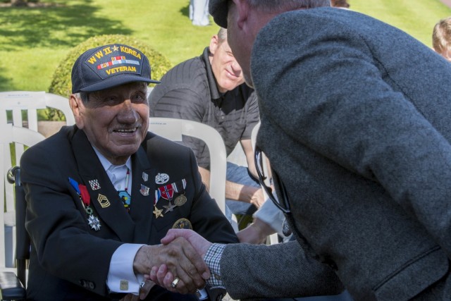 NORMANDY, France (May 27, 2018) World War Two Veteran Pfc. Charles Shay, 16th Infantry Regiment, 1st Infantry Division, meets people attending a Memorial Day and World War I centennial commemoration ceremony at Normandy American Cemetery, France, May 27, 2018. U.S. Naval Forces Europe-Africa, headquartered in Naples, Italy, oversees joint and naval operations, often in concert with allied and interagency partners, to enable enduring relationships and increase vigilance and resilience in Europe and Africa. (U.S. Navy photo by Mass Communication Specialist 2nd Class Russell R. Rhodes Jr./Released)