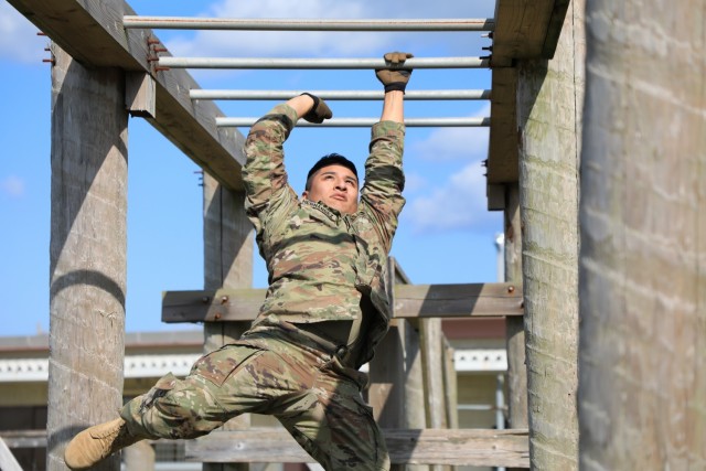 Spc. Timothy M. Hernandez, chemical, biological, radiological, nucleur specialist with 14th Missile Defense Battery, negotiates an obstacle during the 17-event obstacle course portion of the 38th Air Defense Artillery Brigade 2021 Best Warrior Competition at Torri Station, Japan Oct. 26.