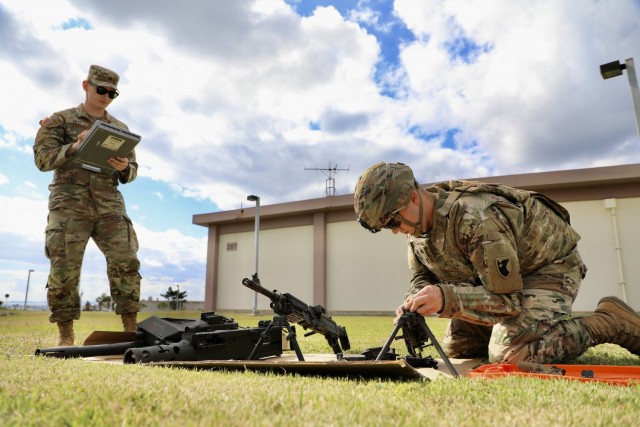 Sgt. Mitchell A. Lapierre, military police with 14th Missile Defense Battery, disassembles a M249 light machine gun while being timed and graded, during the Warrior Task and Drill lanes portion of the 38th Air Defense Artillery Brigade 2021 Best Warrior Competition at Torri Station, Japan Oct. 27.