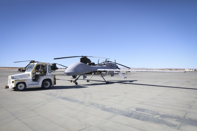 U.S. Army Spc. Nathan Trevino, an MQ-1C Gray Eagle maintainer with Fox Company, 1st Attack Reconnaissance Battalion, 1st Combat Aviation Brigade, taxis a MQ-1C Gray Eagle onto a runway for a flight mission during the U.S. Marine Corps-led,...