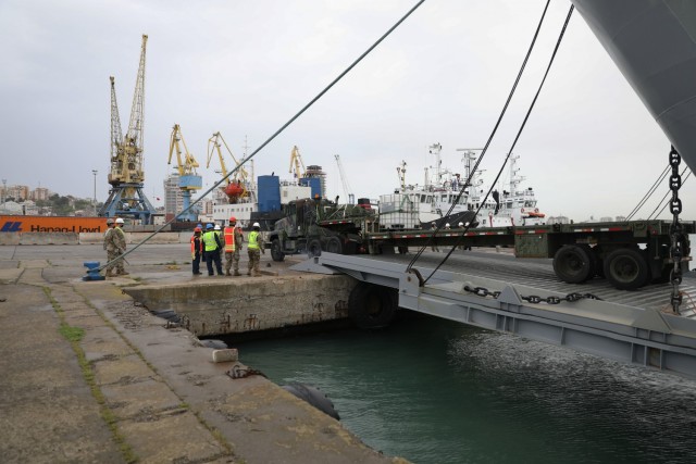 U.S. military personnel stand on the dock at Durres Port watching DEFENDER-Europe 21 Joint Logistics Over-the-Shore operations, May 1, 2021 in Durres, Albania. The Army and the Navy are working together, along with multinational partners and allies, to demonstrate the U.S. Army’s ability to rapidly deliver troops, supplies and equipment quickly, anywhere in the world, in response to crisis. 

DEFENDER-Europe is an annual large-scale U.S. Army-led, multinational, joint exercise designed to build readiness and interoperability between U.S., NATO and partner militaries. This year, more than 28,000 multinational forces from 27 nations will conduct nearly simultaneous operations across more than 30 training areas in more than a dozen countries from the Baltics to the strategically important Balkans and Black Sea Region. Follow the latest news and information about DEFENDER-Europe 21 at: www.EuropeAfrica.army.mil/DefenderEurope. (U.S. Army photo by Staff Sgt. Elizabeth O. Bryson)