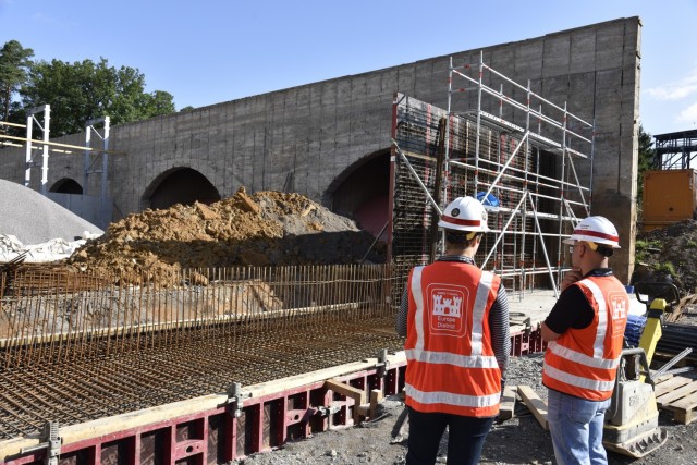 U.S. Army Corps of Engineers, Europe District Project Engineer Silvia Schlepper and Resident Engineer Mario Fuquene discuss progress July 29, 2021 on a noise mitigation project at a Panzer Kaserne training range in Stuttgart as a new wall is...