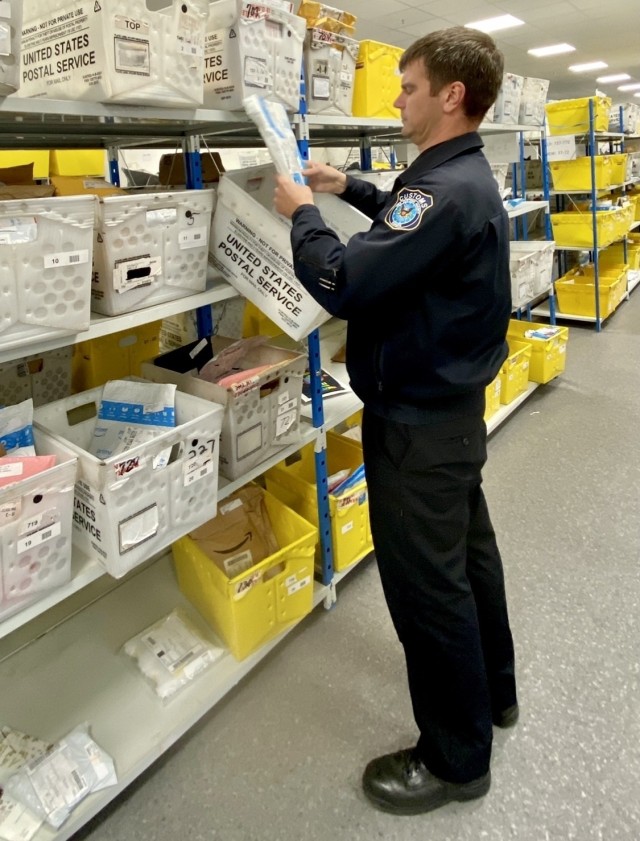 Brandon Oehler, Senior Customs Border Clearance Agent for Wiesbaden, conducts a random mail inspection to find packages that possibly contain prohibited items.