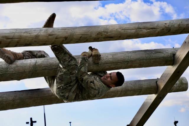 Pfc. Louis M. Wellstood, Army intel analyst with 1st Battalion, 1st Air Defense Artillery Regiment, negotiates an obstacle during the 17-event obstacle course portion of the 38th Air Defense Artillery Brigade 2021 Best Warrior Competition at Torri Station, Japan Oct. 26.