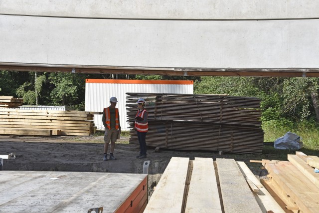 U.S. Army Corps of Engineers, Europe District Project Engineer Silvia Schlepper and a Bauamt partner discuss progress July 29, 2021 on a noise mitigation project at this Panzer Kaserne training range in Stuttgart surrounded by pieces of wood that...