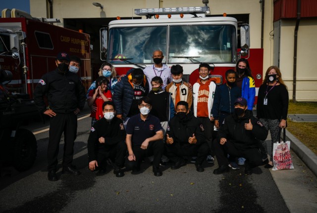 Camp Humphreys Middle School students and staff pose with the firefighters of Fire Station 4 following their tour and hands-on experience during the Learning Impaired Moderate to Severe program’s trip to the fire station on Camp Humphreys, South...