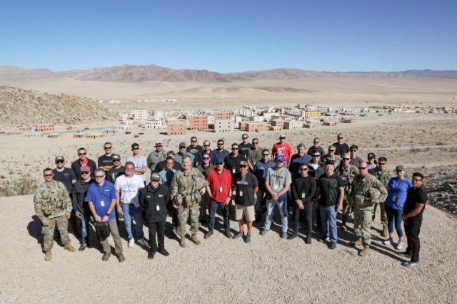Guests pose for a photo with the Commanding General of the National Training Center, near the training city of Razish. Courtesy Photo: Vulture Team