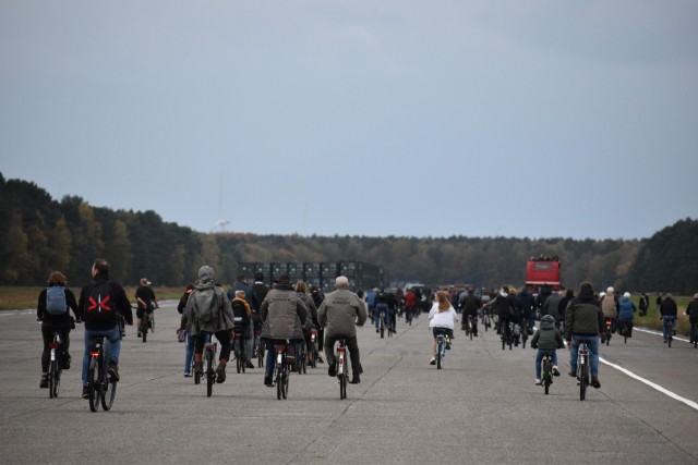 Hundreds of cyclist spectators ride onto the airstrip at Army Prepositioned Stock (APS-2) Site Zutendaal near the Belgian Limburg town of Zutendaal Oct. 31, 2021. The cyclists were there to follow along with a traditional hound-and-horse hunt...