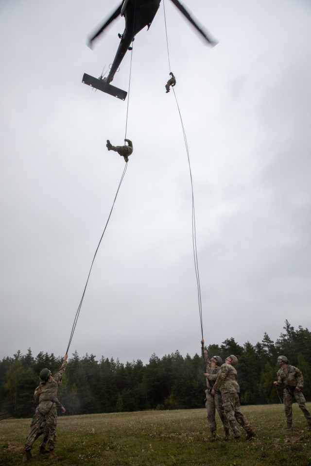 U.S. Army Soldiers rappel from a UH-60M Black Hawk helicopter provided by the 12th Combat Aviation Brigade on Grafenwoehr Training Area, Sept. 16, 2021. The Army National Guard Warrior Training Center coordinated with the 7th Army Training Command's Combined Arms Training Center to host Air Assault School for approximately 270 students from Sept. 8 to 19, 2021. (U.S. Army Photo by Pfc. Jacob Bradford)
