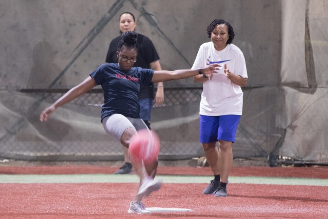 Staff Sgt. Brandy N. Jones, a paralegal specialist assigned to 3rd Expeditionary Sustainment Command, kicks the ball during “Let’s Kick It,” a women’s empowerment event on Oct. 27, 2021, at Camp Arifjan, Kuwait. The event began with a kickball game and concluded with an ice-breaker exercise that involved the Soldiers guessing the first name, age, number of siblings and hobbies of the Soldier standing to their right.