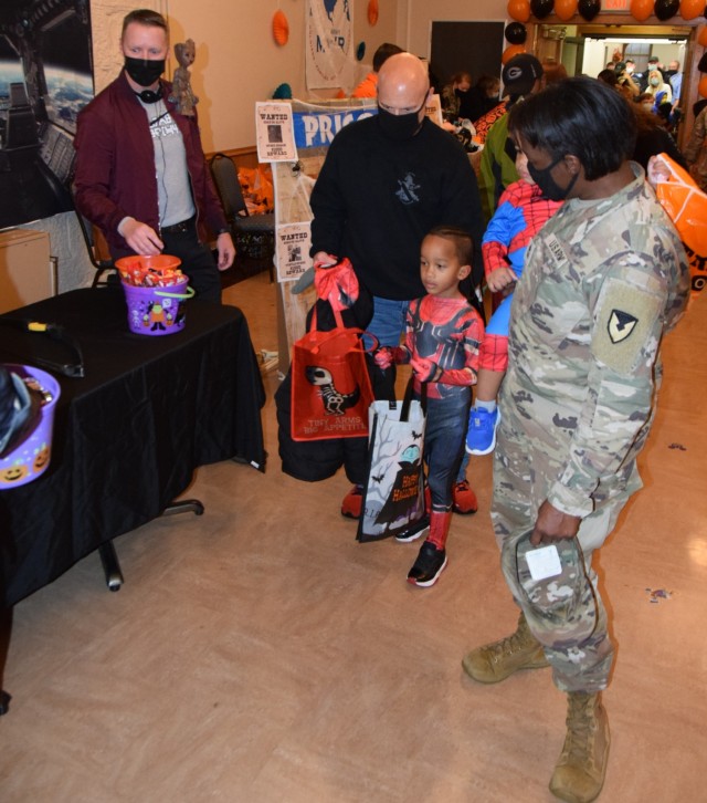 Command Sgt. Maj. John Dobbins, command sergeant major, U.S. Army Garrison Rock Island Arsenal, looks over his table and is ready to engage and give out candy as the first wave of participants pass by at the  Boo on the Rock / Truck or Treat...