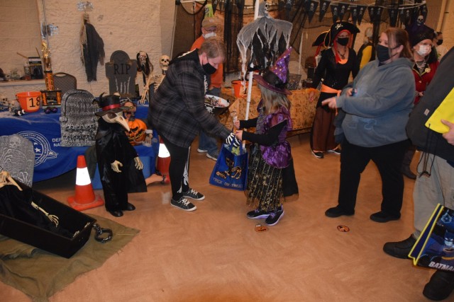 Members of the Rock Island National Cemetery (National Cemetery Administration (NCA) U.S. Department of Veterans Affairs) give out candy at the Boo on the Rock / Truck or Treat celebration held Oct. 28 in Heritage Hall and the Lock & Lounge area...