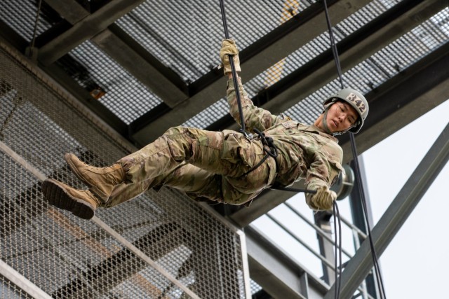 U.S. Army Spc. Beom Jin Paik, Medcom Bavaria Health Clinic pharmacist technician, rappels off of the 60 foot rappel tower on Grafenwoehr Training Area, Sept. 15, 2021. The Army National Guard Warrior Training Center coordinated with the 7th Army Training Command's Combined Arms Training Center to host Air Assault School for approximately 270 students from Sept. 8 to 19, 2021. (U.S. Army Photo by Pfc. Jacob Bradford)
