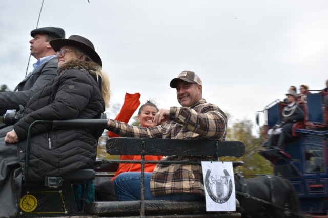 Paul Hossenlopp, U.S. Army Garrison Benelux - Brussels deputy garrison site manager, and wife Shelley Hossenlopp ride in the back of a carriage following along the Zutendaal slipjacht Oct. 31, 2021 at Army Prepositioned Stock (APS-2) Site...