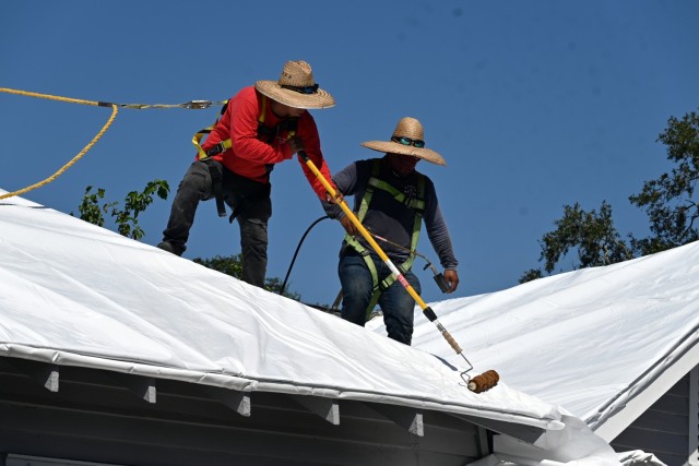 A U.S. Army Corps of Engineers contractor applies a shrinkable, plastic sheeting to a home in New Orleans that was damaged by Hurricane Ida. USACE, in cooperation with the Federal Emergency Management Agency and the state of Louisiana, recently completed a pilot program to explore temporary roofing options for homes that may otherwise have been disqualified from the USACE Operation Blue Roof program.