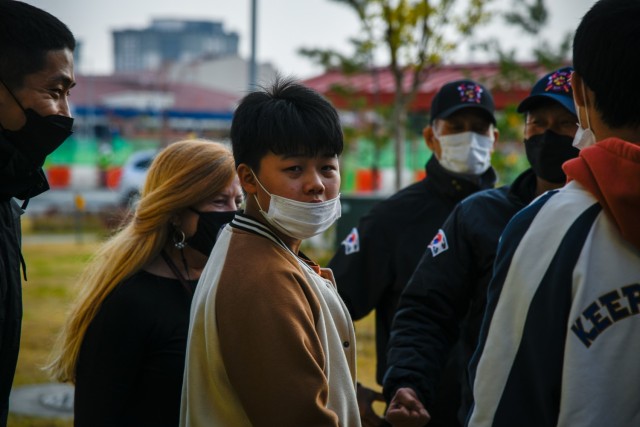Lori Pyers-Goodwin, a teacher at Humphreys Middle School, and student Seongjoo Kim (front) meet with firefighters during the Learning Impaired Moderate to Severe program’s trip to Fire Station 4 on Camp Humphreys, South Korea, Nov. 1, 2021. The...