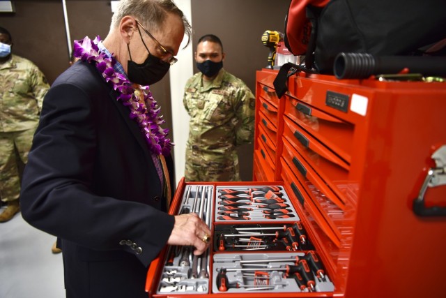Dr. Brian Lein, Defense Health Agency assistant director, examines tools utilized by the Biomedical Equipment Technician shop at Joint Base Pearl Harbor-Hickam, Hawaii, Oct. 19, 2021. The BMET shop provides both in-clinic service, and a workshop to service equipment that is used by the 15th Medical Group. (U.S. Air Force photo by 1st Lt. Benjamin Aronson)