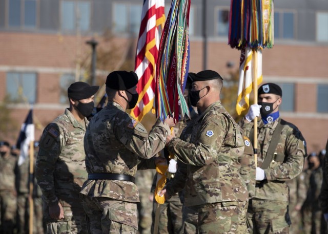 FORT KNOX, Ky. (Nov. 4, 2021) – Outgoing V Corps Command Sgt. Maj. Billy Webb passes the colors to V Corps Commanding General Lt. Gen. John Kolasheski during a change of responsibility ceremony at the V Corps Headquarters at Fort Knox, Kentucky, Nov. 4. During the ceremony, Webb relinquished responsibility as the V Corps senior enlisted leader to Command Sgt. Maj. Raymond Harris. (U.S. Army photo by Pfc. Devin Klecan/released)
