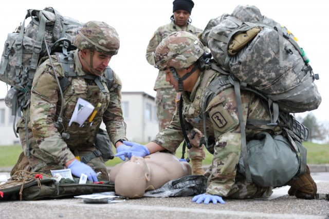 Staff Sgt. Dusty Edwards, left, an ancillary platoon sergeant for the 512th Field Hospital’s Headquarters and Headquarters Company, and Sgt. 1st Class Justin Keum, an operating room NCO assigned to the 512th Field Hospital, provide medical care to a simulated casualty during the Fiscal Year 2022 30th Medical Brigade and Regional Health Command Europe Best Medic Competition Oct. 30 at Sembach Kaserne, Germany.