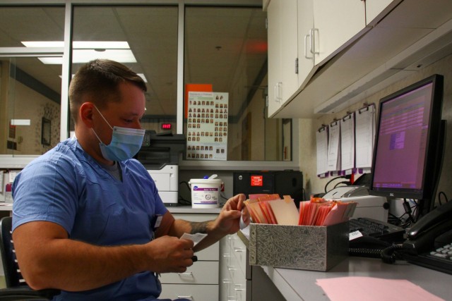Kentucky Army National Guard Sgt. Alex Kropf, a mechanic with 307th Maintenance Company, receives an order for processing in the laboratory at the Medical Center at Bowling Green in Bowling Green, KY October 20, 2021. The Kentucky National Guard...