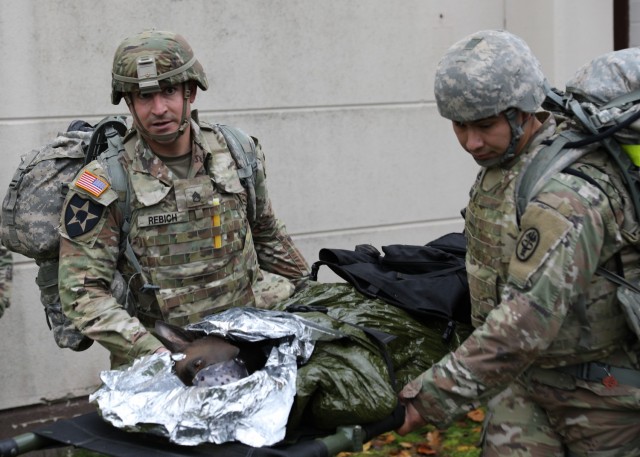 Staff Sgt. Timothy Rebich, left, a respiratory therapist assigned to Landstuhl Regional Medical Center, and Staff Sgt. Alejandro Preciado, an animal care specialist at Veterinary Medical Center Europe, transport a simulated injured military working dog during the Fiscal Year 2022 30th Medical Brigade and Regional Health Command Europe Best Medic Competition conducted Oct. 30 at Sembach Kaserne, Germany. Rebich and Preciado will represent Regional Health Command Europe in the 2022 Command Sgt. Maj. Jack L. Clark Jr. U.S. Army Best Medic Competition at Ford Hood, Texas in January.