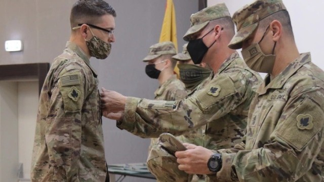 Sgt. Maj. Alex Young pins staff sergeant rank on Joseph Nowak at the Joint Training Center in Jordan on Jan. 28 2021. The Army recently announced that its temporary promotion policy will be extended to all non-commissioned officer ranks. 
