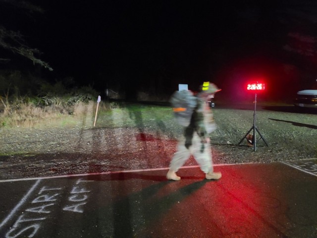 Master Sgt. William Booth, assigned to Tripler Army Medical Center, crosses the finish line of the 12-mile road march with a time of 2:26:26, cementing his win in the Regional Health Command-Pacific Best Medic Competition, Nov. 2.