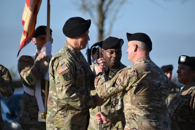Command Sgt. Maj. Gary E. Yurgans, left, accepts a sword from Col. James Yastrzemsky, U.S. Army Garrison Benelux commander, during a change of responsibility ceremony Nov. 5, 2021 at Chièvres Air Base, Belgium. Accepting the sword means that...