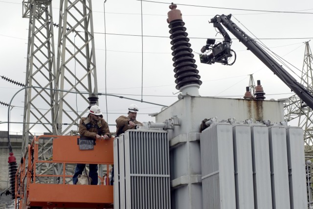 Senior Electrician Ron Gatlin (Right) and Electrician Kyle Mosakowski are captured on video Nov. 2, 2021 working in the Center Hill Dam Switchyard in Lancaster, Tennessee, for a U.S. Army Corps of Engineers National Inventory of Dams video production. The Nashville District operates and maintains the project on the Caney Fork River in Lancaster, Tennessee. (USACE Photo by Leon Roberts)