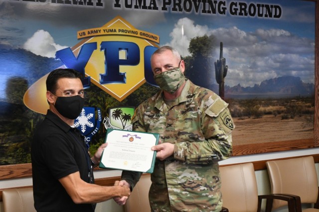 Yuma Proving Ground Commander Col. Patrick McFall presented Ammunition and Armaments Division Chief Anthony Gingras and Ammunition Branch Chief Samantha Howerton the Civilian Service Achievement Medal on Oct. 25.