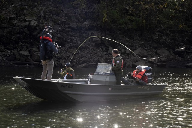 Park Ranger Gary Bruce maneuvers a Corps of Engineers boat into position Nov. 2, 2021 to allow an Open Jaw Productions film crew to obtain imagery of Phillip Sliger fly fishing in the Caney Fork River below Center Hill Dam in Lancaster, Tennessee. Trout fishing is a popular recreation activity in the tailwater at the project operated and maintained by the U.S. Army Corps of Engineers Nashville District. The imagery is being used for a USACE National Inventory of Dams video production. (USACE Photo by Leon Roberts)