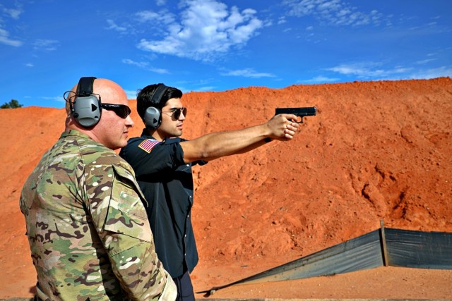 7th Special Forces Group (Airborne) Master Sgt. Ivan Morera coaches and observes JM Correa shooting down range at Element Training Facility, Holt, Fla., Oct. 27, 2021. Morera coaches Correa through the steps necessary to become a skilled marksman. (U.S. Army photos by Spc. Christopher Sanchez.)