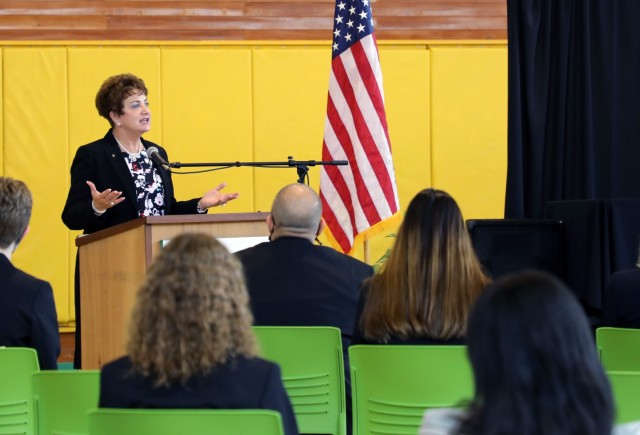 Lois Rapp, DoDEA Pacific Director of Student Excellence, speaks to an assembled crowd at the grand re-opening ceremony celebrating the renewal of Robert D. Edgren Middle High School and it's transformation into a 21st century school. The project, headed by the U.S. Army Corps of Engineers - Japan District represents a $35 million dollar investment in America's youth.