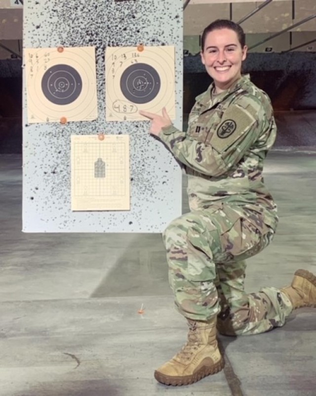 Dr. (Capt.) Elizabeth Anthony, an Army veterinarian and officer in charge of the Yokota Veterinary Treatment Facility, poses with her targets after taking top shot at the Yokota Air Base Excellence Competition Rifle Match, Sept. 2, 2021.