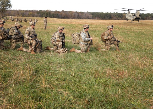 Soldiers with 1st Battalion, 327th Infantry Regiment, 1st Infantry Brigade Combat Team, 101st Airborne Division (Air Assault), wait to load onto a CH-47 Chinook during training as part of Lethal Eagle, November 3, 2021, at Corregidor Drop Zone, Fort Campbell, KY.